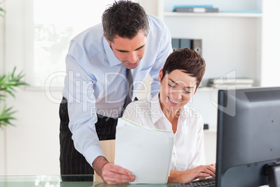 Businessman showing document to his colleague