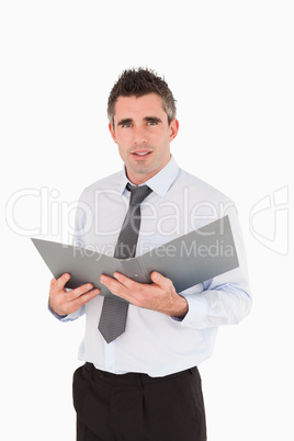 Portrait of a man holding a binder