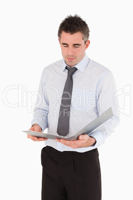 Portrait of a man looking a binder