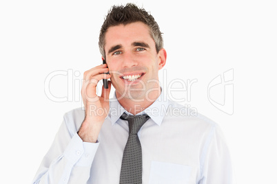 Smiling man making a phone call