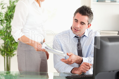 Businessman receiving a document from his secretary