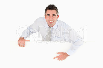 Businessman pointing at blank panel