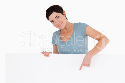 Woman pointing at something on a panel