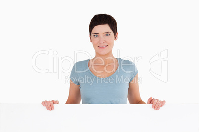 Woman standing behind a blank panel