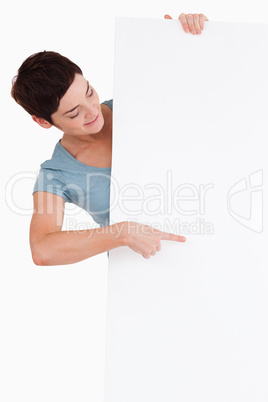 Brunette pointing at a blank panel