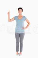 Good looking woman pointing at blank space