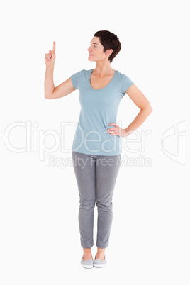 Good looking woman pointing at copy space