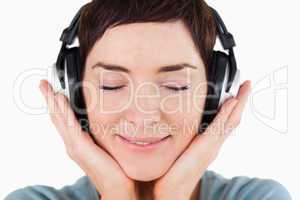 Close up of a delighted woman listening to music