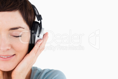 Close up of a delighted woman enjoying some music