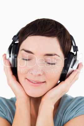 Portrait of a delighted woman listening to music music