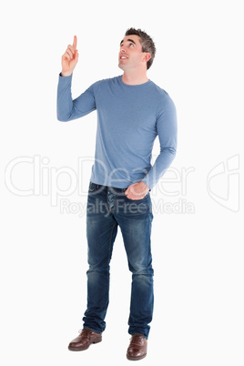 Handsome man pointing at copy space