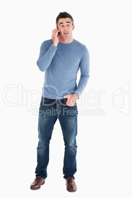 Surprised man answering the phone
