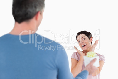 Brunette woman touched by her husband's present