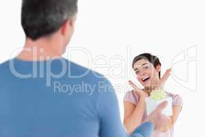 Brunette woman touched by her husband's present
