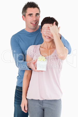 Portrait of a man surprising his wife with a present