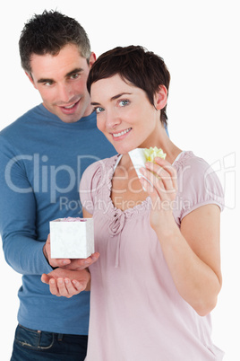 Portrait of a man surprising his fiance with a present