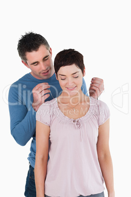 Man offering a necklace to his wife