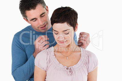 Man offering a necklace to his smiling wife