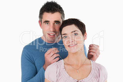 Husband offering a necklace to his wife