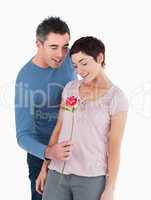 Husband offering a rose to his wife