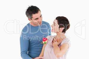 Husband offering a rose to his delighted wife