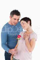 Husband offering a rose to his happy wife