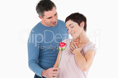 Husband offering a rose to his smiling wife