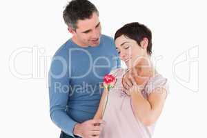 Husband offering a rose to his smiling wife