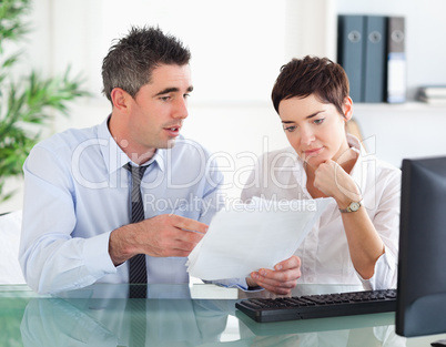 Man pointing at something to his colleague on a document