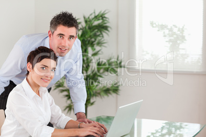 Manager and his secretary posing with a laptop