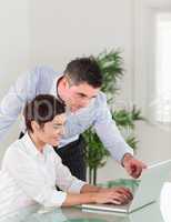 Portrait of a manager and his secretary working with a laptop