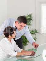 Portrait of a manager pointing at something to his secretary on