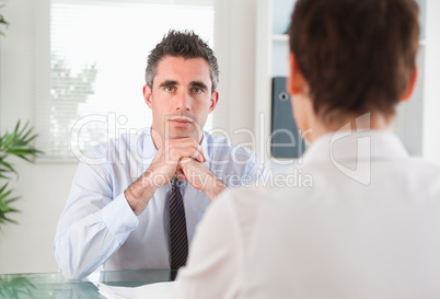 Handsome manager interviewing an applicant