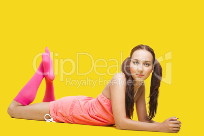 Beauty woman like teenager lay on yellow