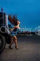 Young beauty girl posing near steel truck