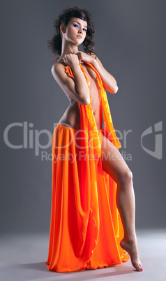 beauty naked dancer posing in orange veil