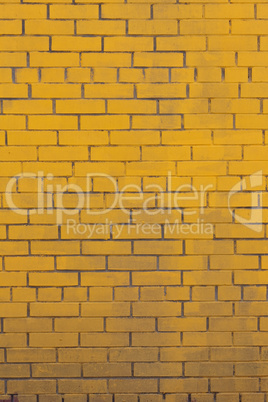 Background with old yellow painted brick wall