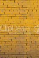 Background with old yellow painted brick wall