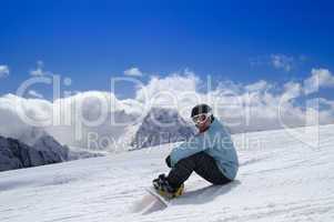 Snowboarder sitting on the snow