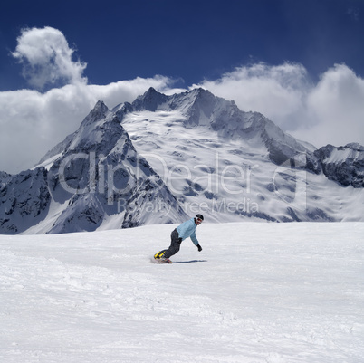 Snowboarder in high mountains