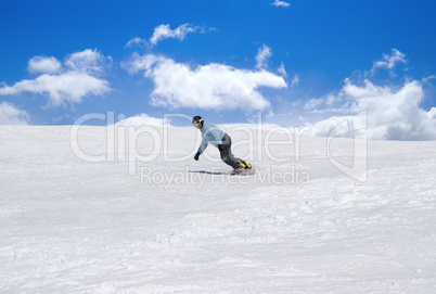 Snowboarder against blue sky