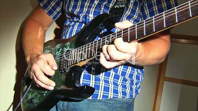 playing at electric guitar