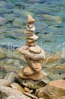 balanced stone structure on rocky shore