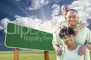 African American Family in Front of Blank Green Road Sign