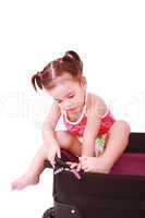 Little girl in a suitcase. Isolated on a white background