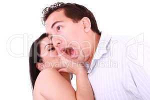 Woman tells something into surprised guy's ear isolated on white