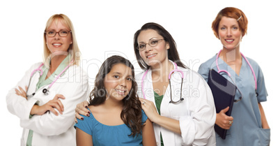 Hispanic Female Doctor with Child Patient and Colleagues Behind