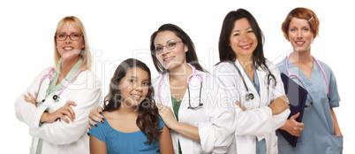 Hispanic Female Doctor with Child Patient and Colleagues Behind