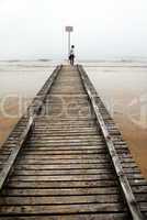 Teenage girl on old sea pier