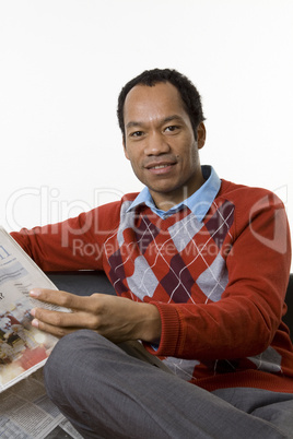 Smart casual male reading trade news in the paper
